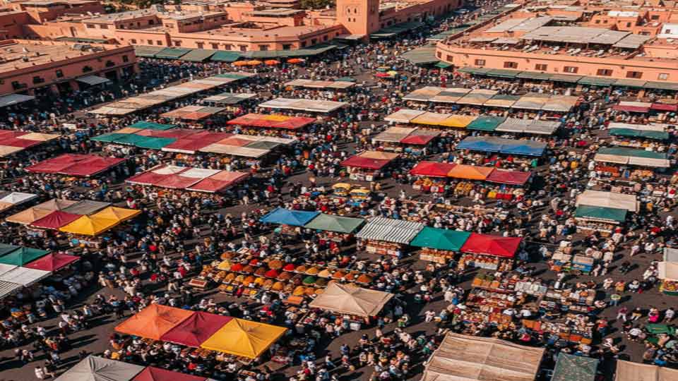 birds eye view ai prompt example of a busy marketplace in marrakech, colorful stalls and crowds